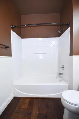 a bathroom with a bathtub and a toilet