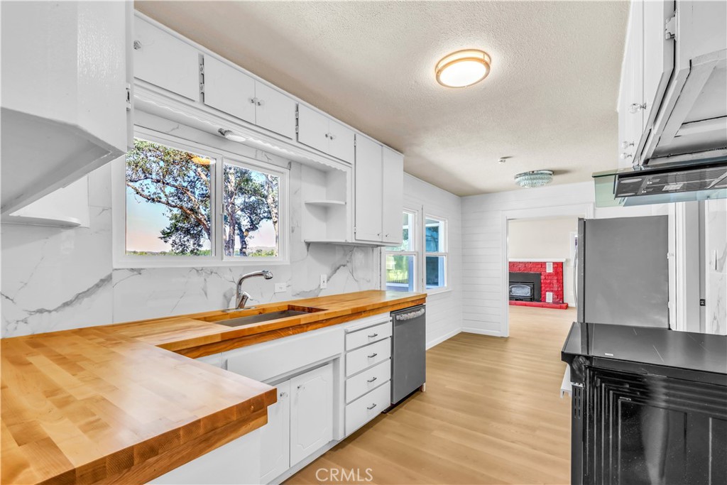 15905 Kugelman Street Lower Lake, CA 95457 - Photo 54 of 75 a kitchen with stainless steel appliances a sink dishwasher and cabinets with wooden floor