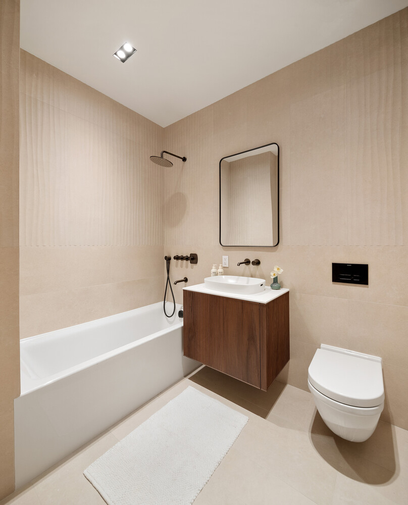 28 Herbert Street, Unit B4 Brooklyn, NY 11222 - Photo 12 of 17 a bathroom with a bathtub shower sink vanity mirror and toilet