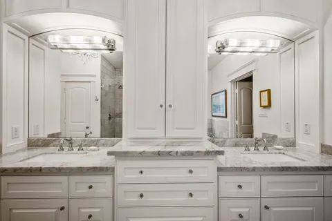 a bathroom with a granite countertop sink mirror and