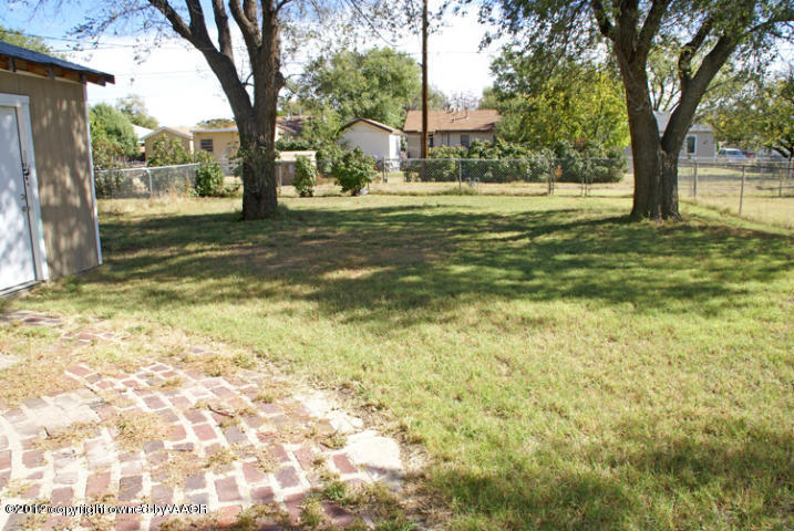 4115 South Ong Street Amarillo, TX 79110 - Photo 14 of 15 a view of a trees in a yard next to a building