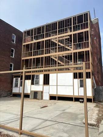a view of a brick house with a street