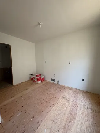 a view of a room with wooden floor and utility room