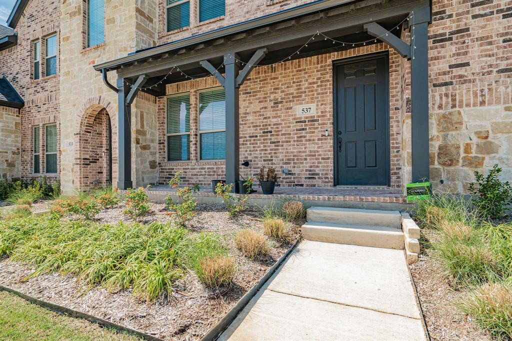 a view of a house with a small yard and plants