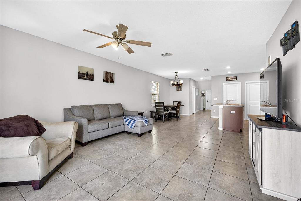 9616 Lemon Drop Loop Sun City Center, FL 33573 - Photo 19 of 53 a living room with furniture and kitchen view