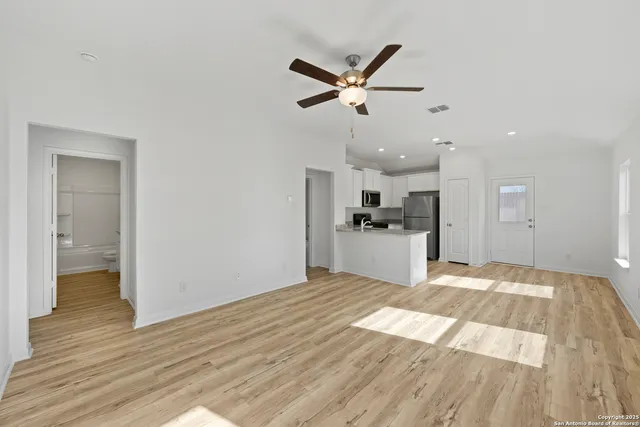 a view of a kitchen with wooden floor and a sink