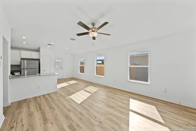 a view of workspace with wooden floor and a window