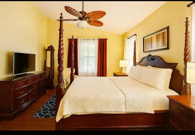 a bedroom with a bed and a flat screen tv