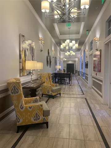 a lobby room with furniture chandelier and a chandelier