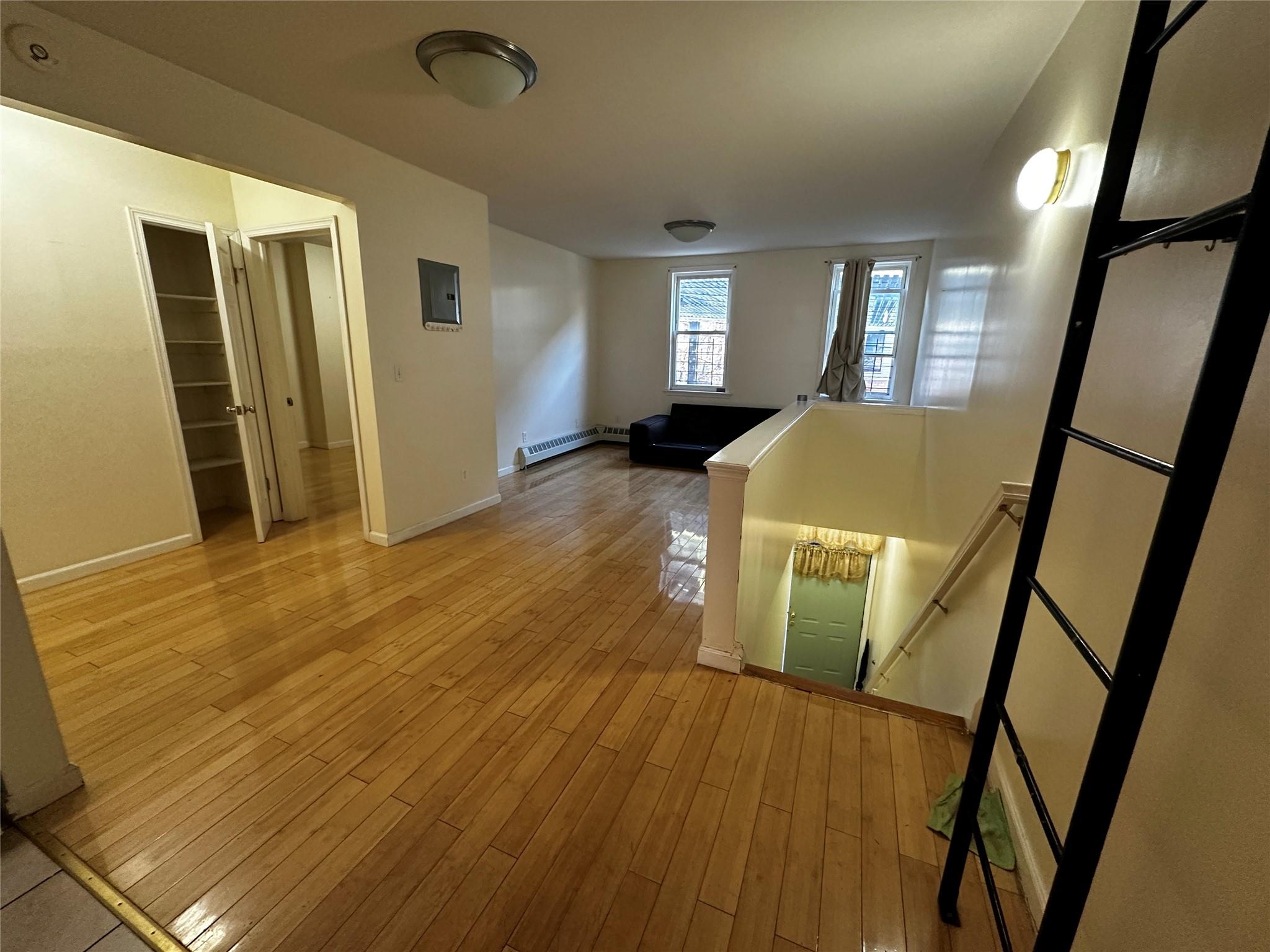 1316 Myrtle Avenue Brooklyn, NY 11221 - Photo 23 of 32 2ND FLR Hall featuring wood-type flooring, baseboard heating, and electric panel