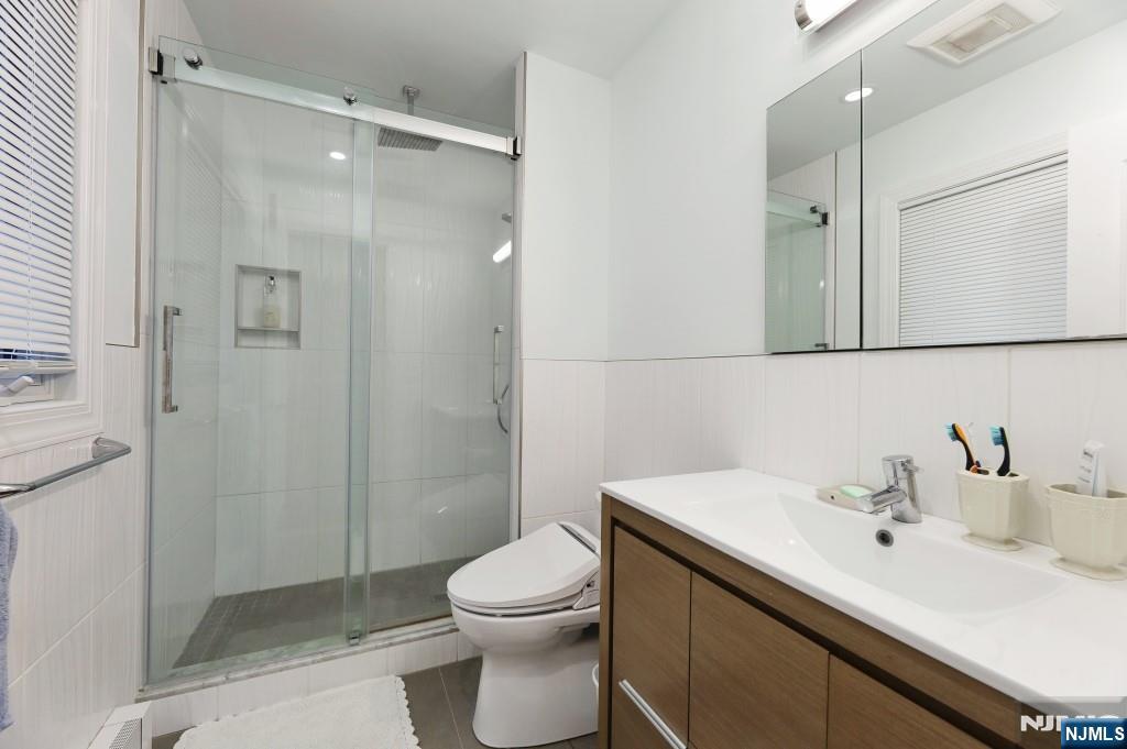 83 Hampshire Road Washington Township, NJ 07676 - Photo 15 of 40 a bathroom with a sink toilet and shower