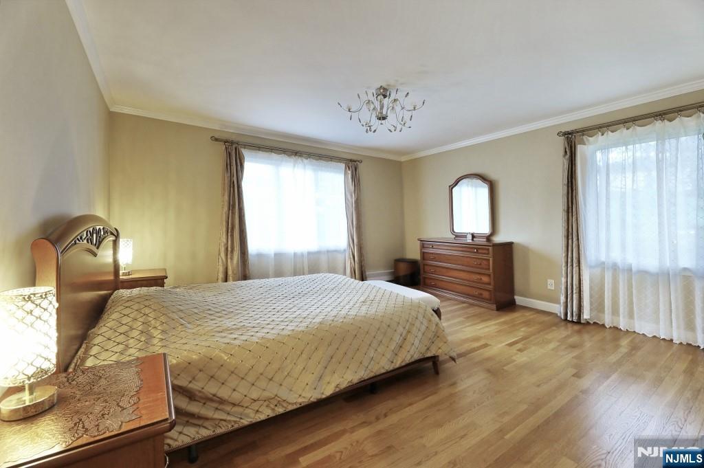 83 Hampshire Road Washington Township, NJ 07676 - Photo 16 of 40 a bedroom with a bed and wooden floor