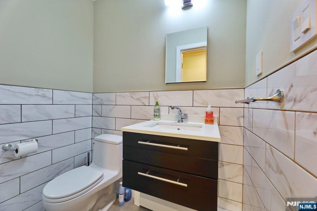 83 Hampshire Road Washington Township, NJ 07676 - Photo 23 of 40 a bathroom with a toilet sink vanity and mirror