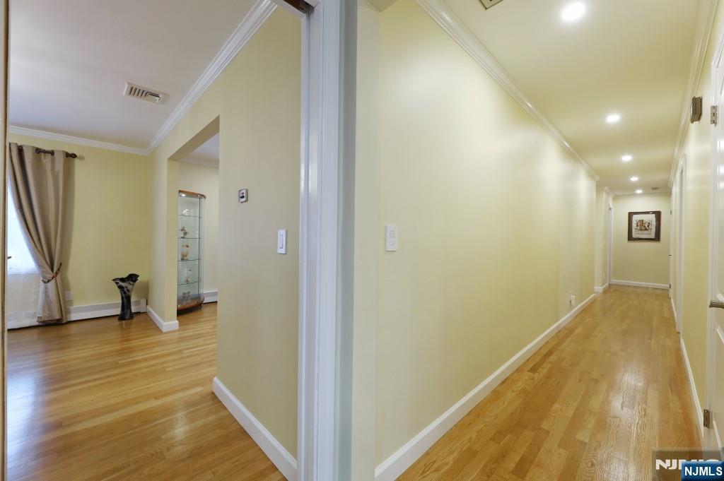 83 Hampshire Road Washington Township, NJ 07676 - Photo 24 of 40 a view of a hallway with wooden floor and a bathroom