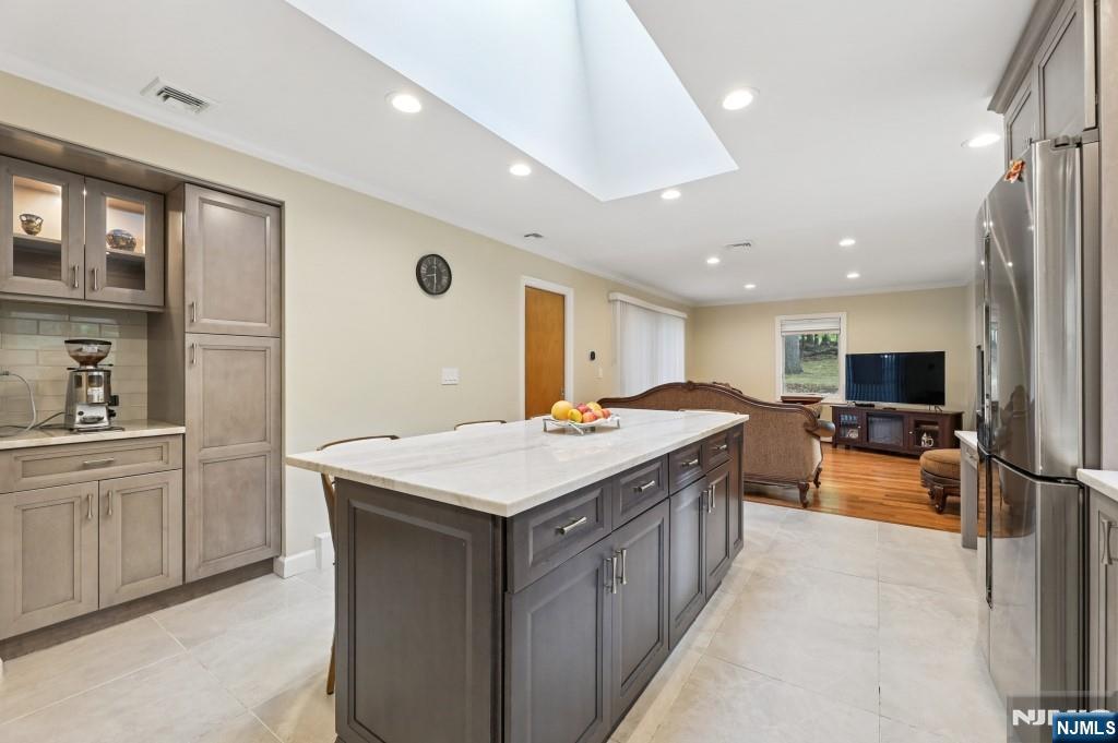 83 Hampshire Road Washington Township, NJ 07676 - Photo 28 of 40 a large kitchen with kitchen island a sink stove and cabinets