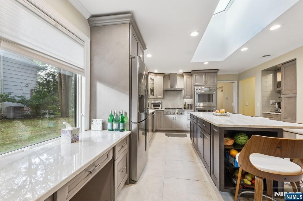 83 Hampshire Road Washington Township, NJ 07676 - Photo 30 of 40 a kitchen with stainless steel appliances granite countertop a sink and a refrigerator