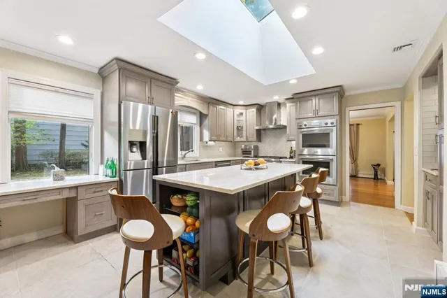a kitchen with a table chairs sink and cabinets