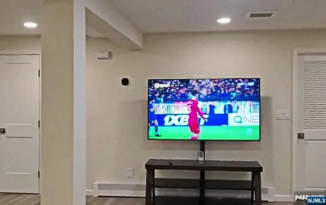 a kitchen with stainless steel appliances a refrigerator and wooden floor