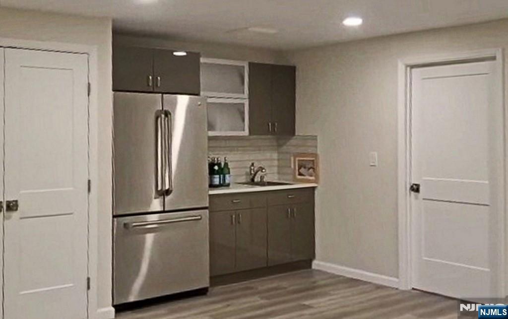 83 Hampshire Road Washington Township, NJ 07676 - Photo 5 of 40 a kitchen with stainless steel appliances a refrigerator and wooden floor