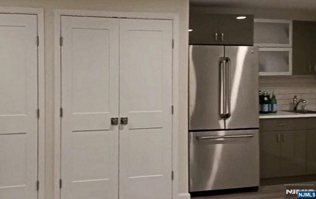 83 Hampshire Road Washington Township, NJ 07676 - Photo 6 of 40 a view of a refrigerator in kitchen and white cabinets