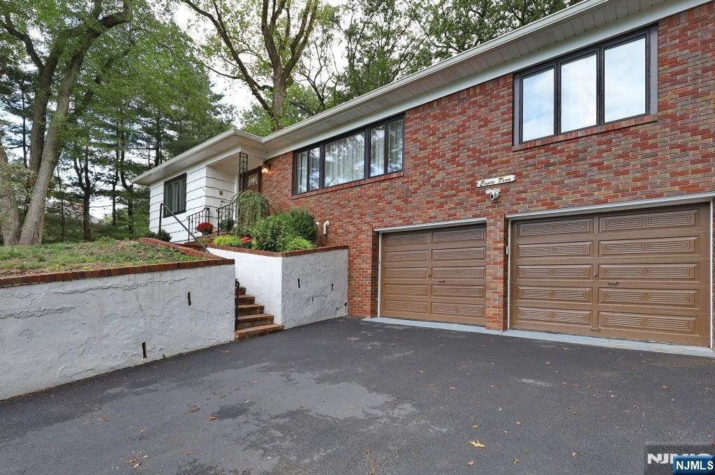 83 Hampshire Road Washington Township, NJ 07676 - Photo 10 of 40 a view of a house with a yard and potted plants