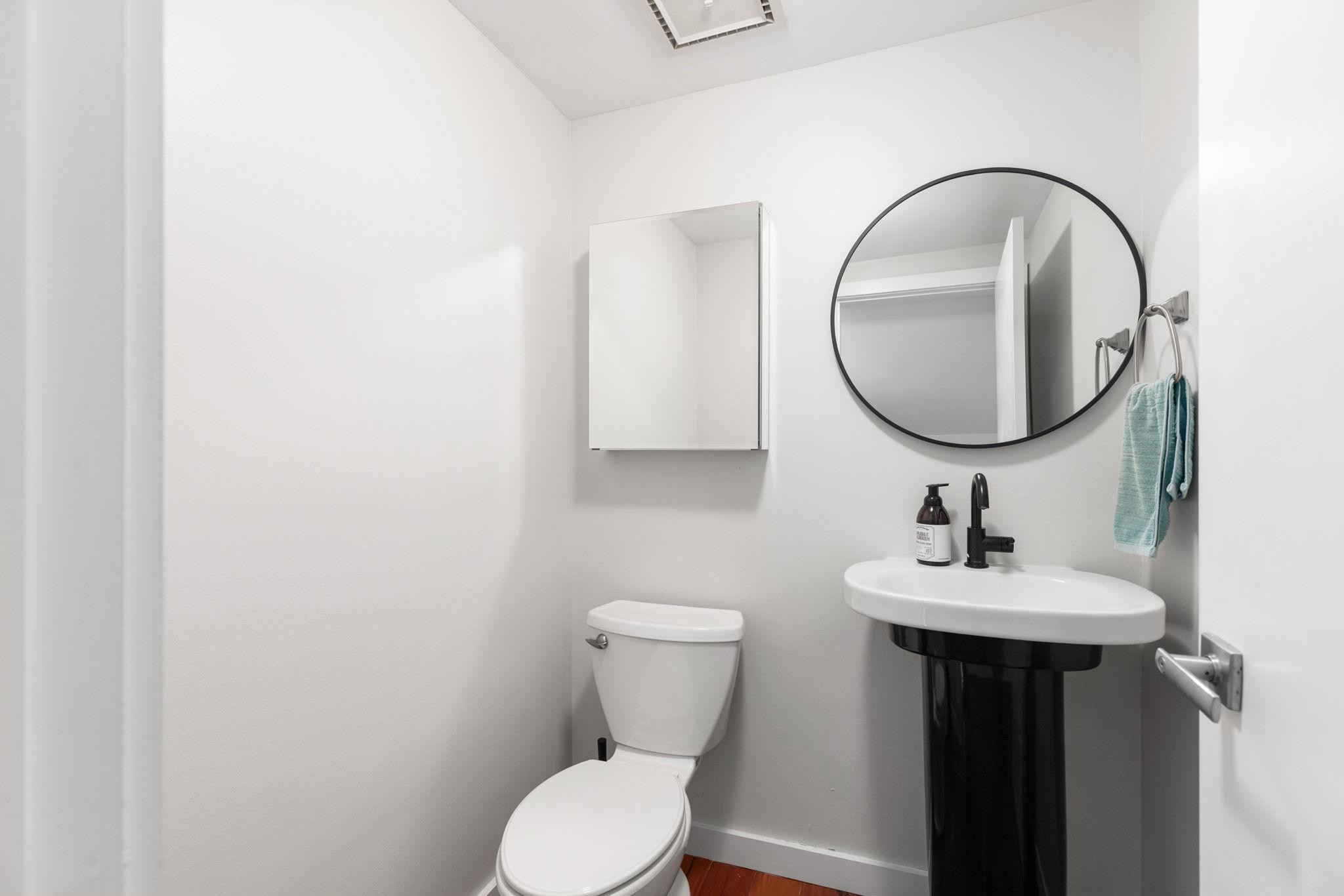 2204 Timberlake Drive Raleigh, NC 27604 - Photo 26 of 100 a bathroom with a toilet sink and mirror