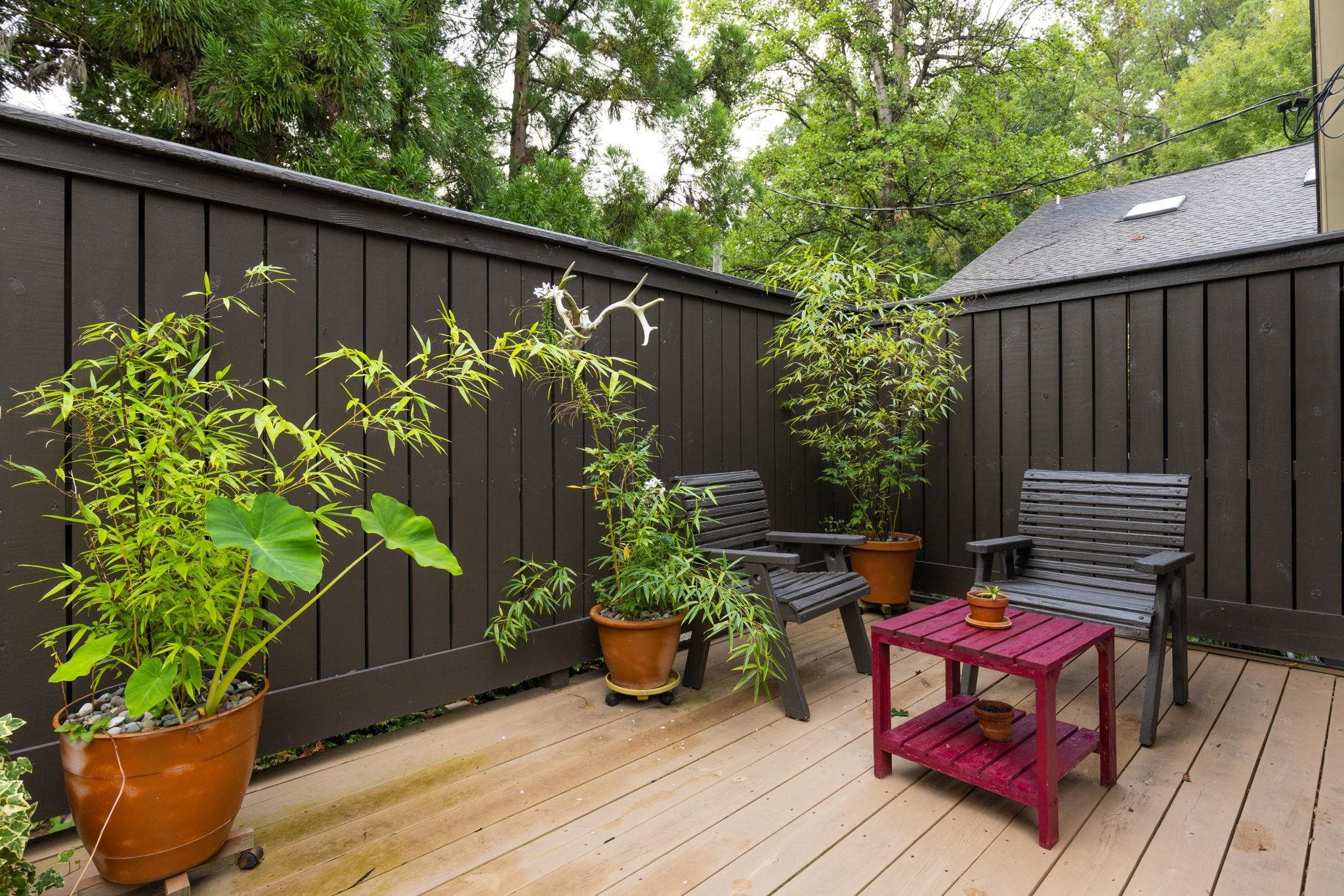 2204 Timberlake Drive Raleigh, NC 27604 - Photo 46 of 100 a backyard of a house with wooden floor table and chairs