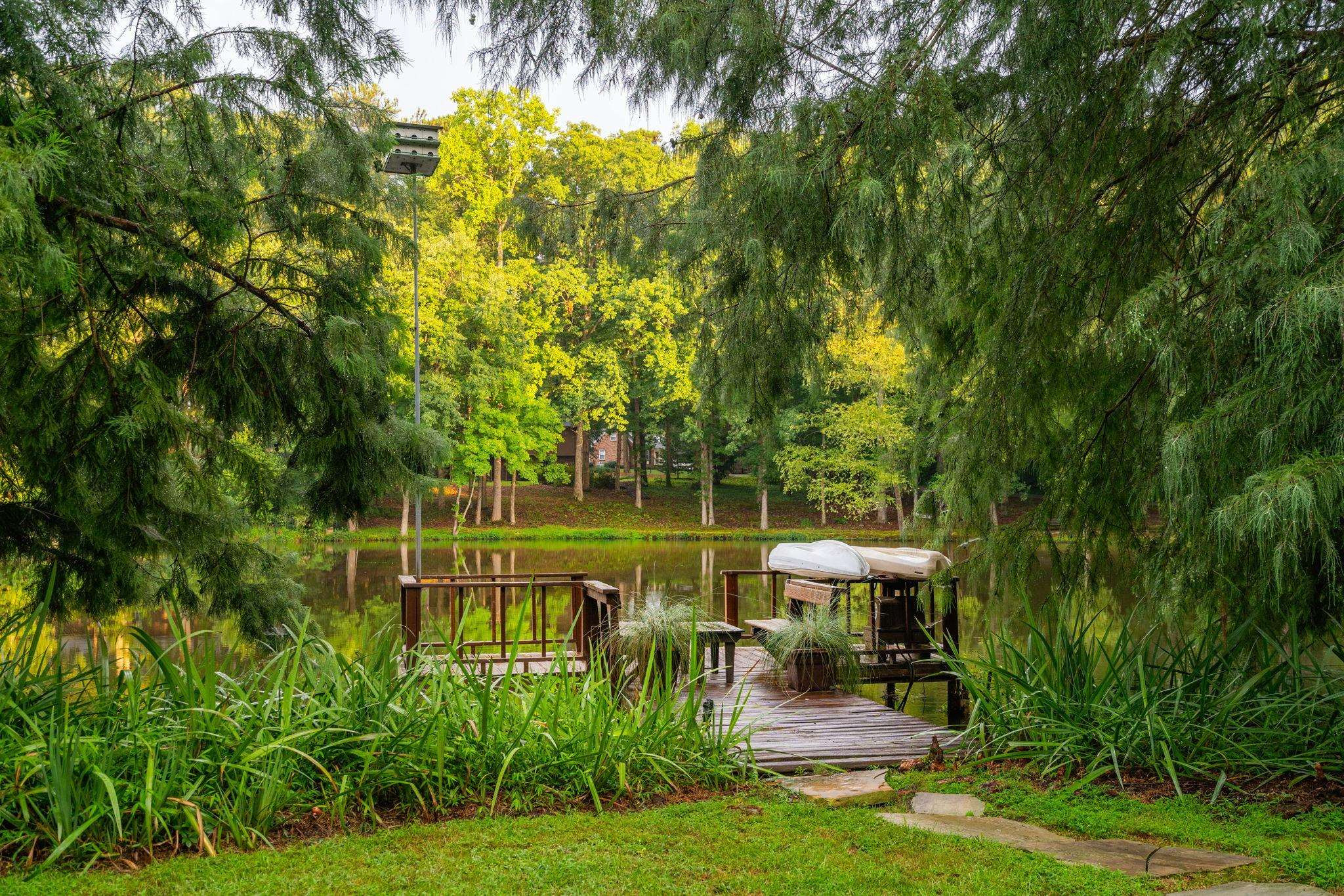 2204 Timberlake Drive Raleigh, NC 27604 - Photo 65 of 100 a view of a garden with lawn chairs under an umbrella