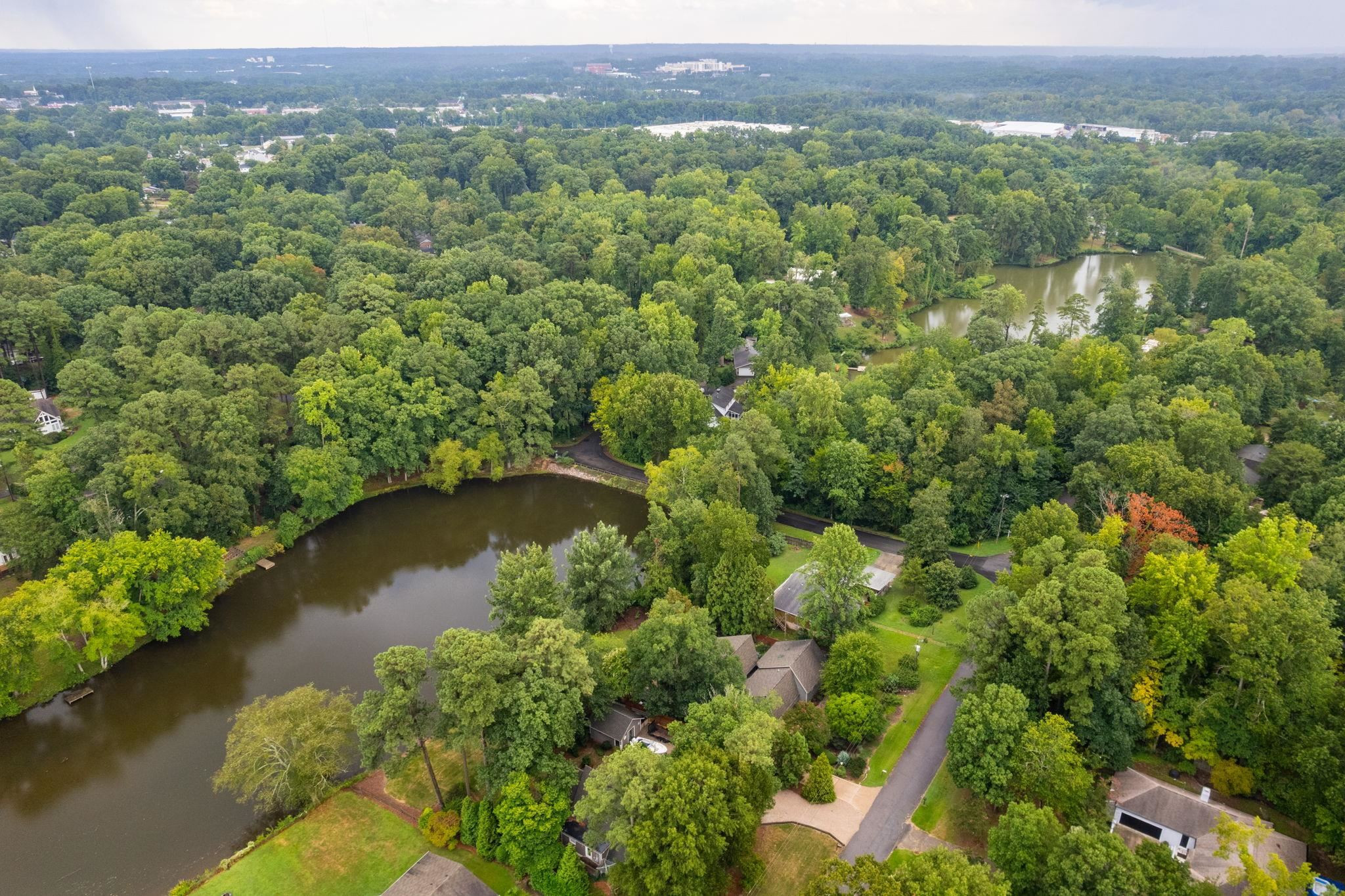 2204 Timberlake Drive Raleigh, NC 27604 - Photo 95 of 100 an aerial view of a houses with a lake view