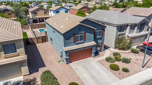an aerial view of a house with garden space and a car parked