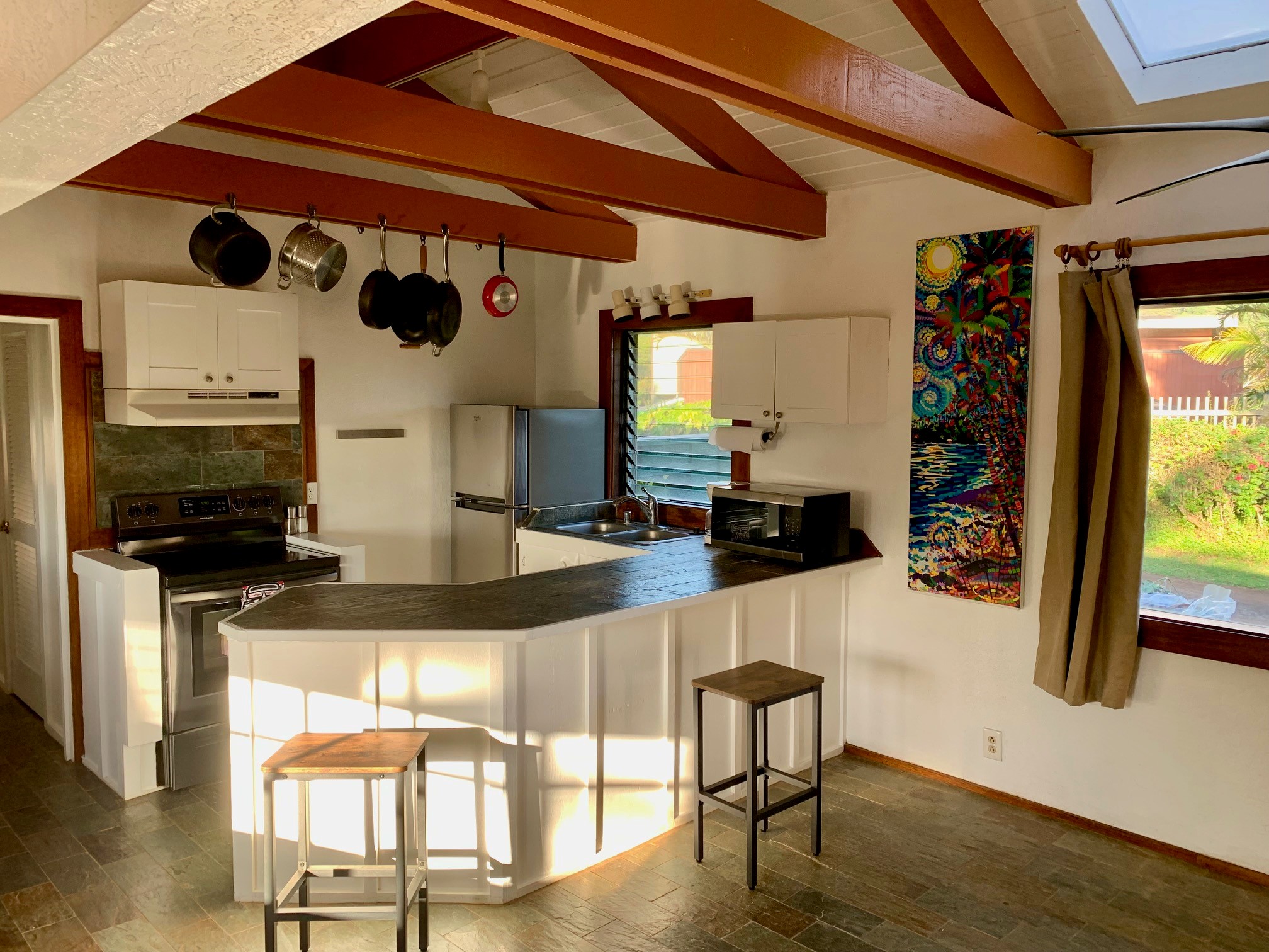 3198 Wawae Road Kalaheo, HI 96741 - Photo 12 of 30 a kitchen with stainless steel appliances granite countertop a stove and a wooden cabinets