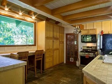3198 Wawae Road Kalaheo, HI 96741 - Photo 4 of 30 a open kitchen with stainless steel appliances kitchen island granite countertop a refrigerator and a stove top oven