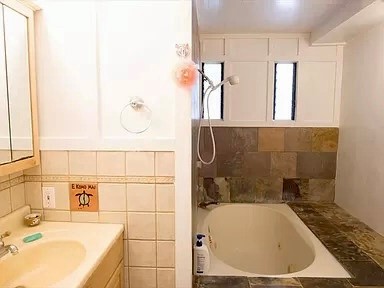 3198 Wawae Road Kalaheo, HI 96741 - Photo 8 of 30 a bathroom with a tub sink and mirror