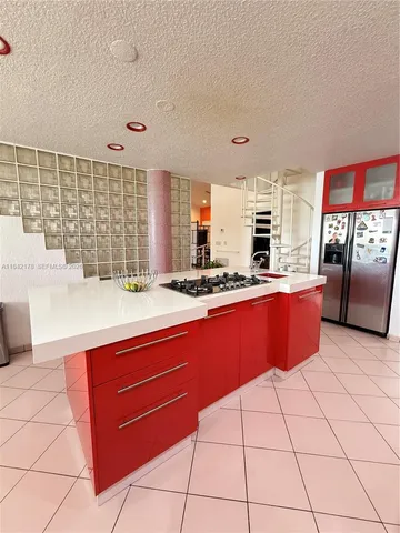 a kitchen with stainless steel appliances kitchen island granite countertop a sink and cabinets