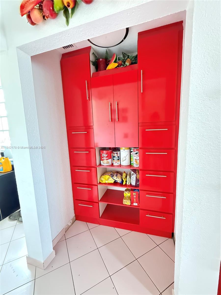 747 West 78th Street Hialeah, FL 33014 - Photo 13 of 38 a yellow room with rug and a chair