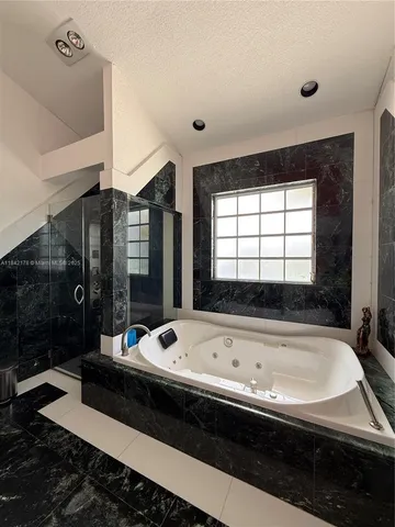 a bathroom with a bathtub and shower