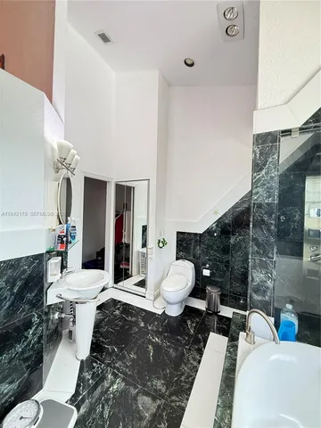 a living room with furniture and a toilet