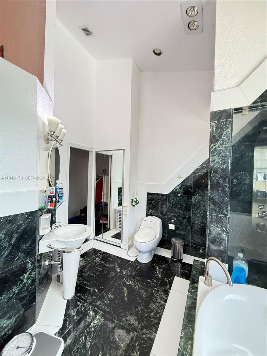 747 West 78th Street Hialeah, FL 33014 - Photo 18 of 37 a living room with furniture and a toilet