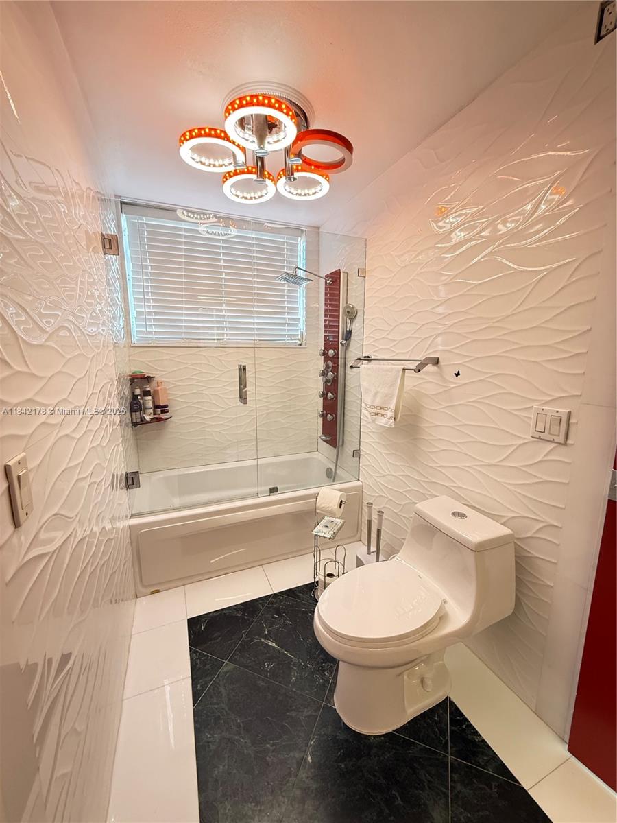 747 West 78th Street Hialeah, FL 33014 - Photo 23 of 38 a bathroom with a sink a toilet a mirror and bathtub