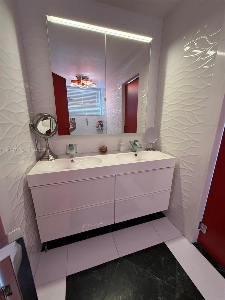 747 West 78th Street Hialeah, FL 33014 - Photo 24 of 38 a bathroom with a sink and a mirror