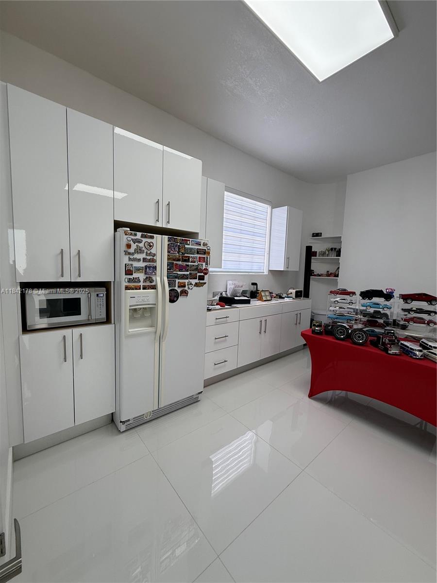 747 West 78th Street Hialeah, FL 33014 - Photo 29 of 38 a kitchen with stainless steel appliances kitchen island granite countertop a stove a sink and a refrigerator