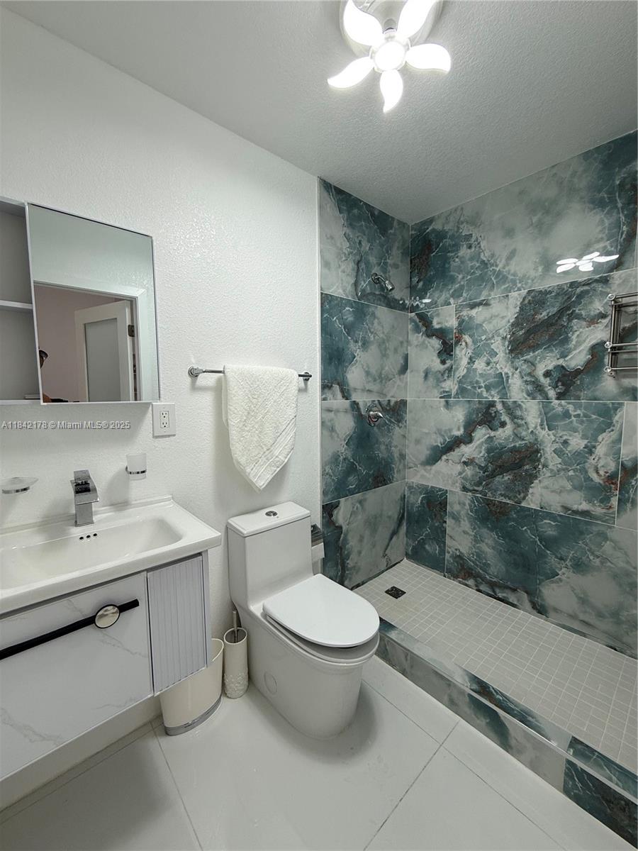 747 West 78th Street Hialeah, FL 33014 - Photo 31 of 38 a bathroom with a sink a toilet and a mirror