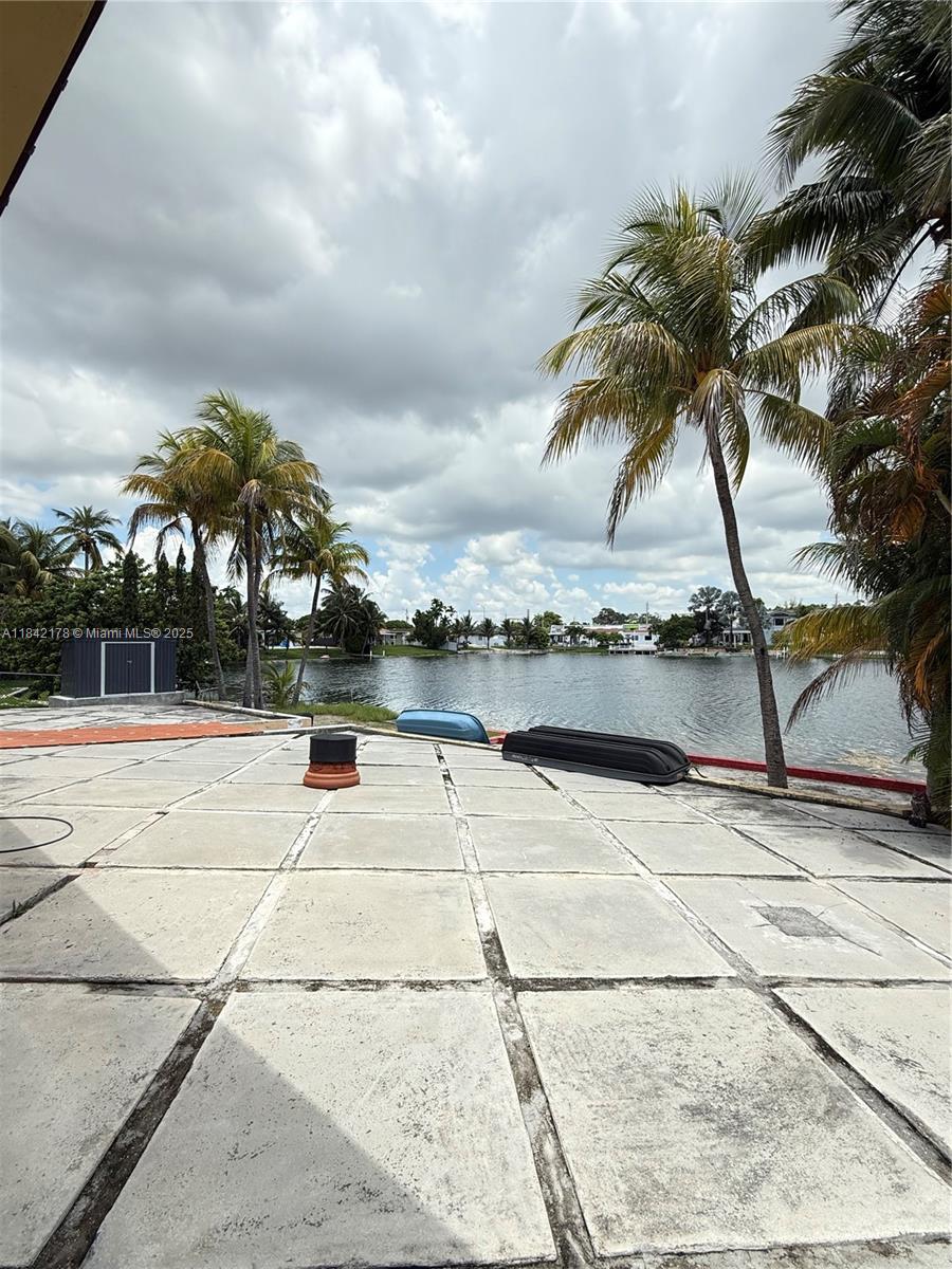 747 West 78th Street Hialeah, FL 33014 - Photo 32 of 38 a view of pool with lawn chairs and iron fence