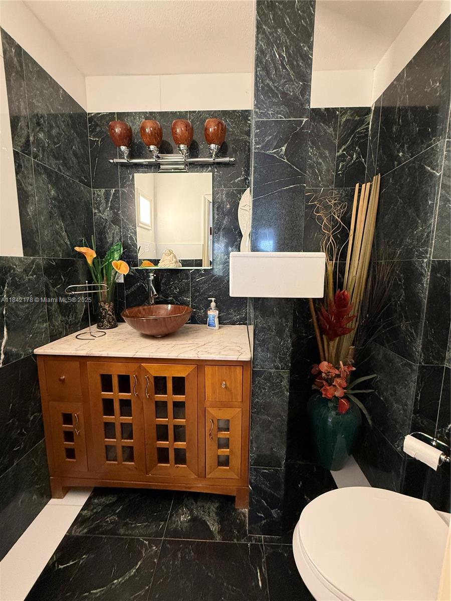 747 West 78th Street Hialeah, FL 33014 - Photo 4 of 38 a view of a balcony with chairs and a potted plant