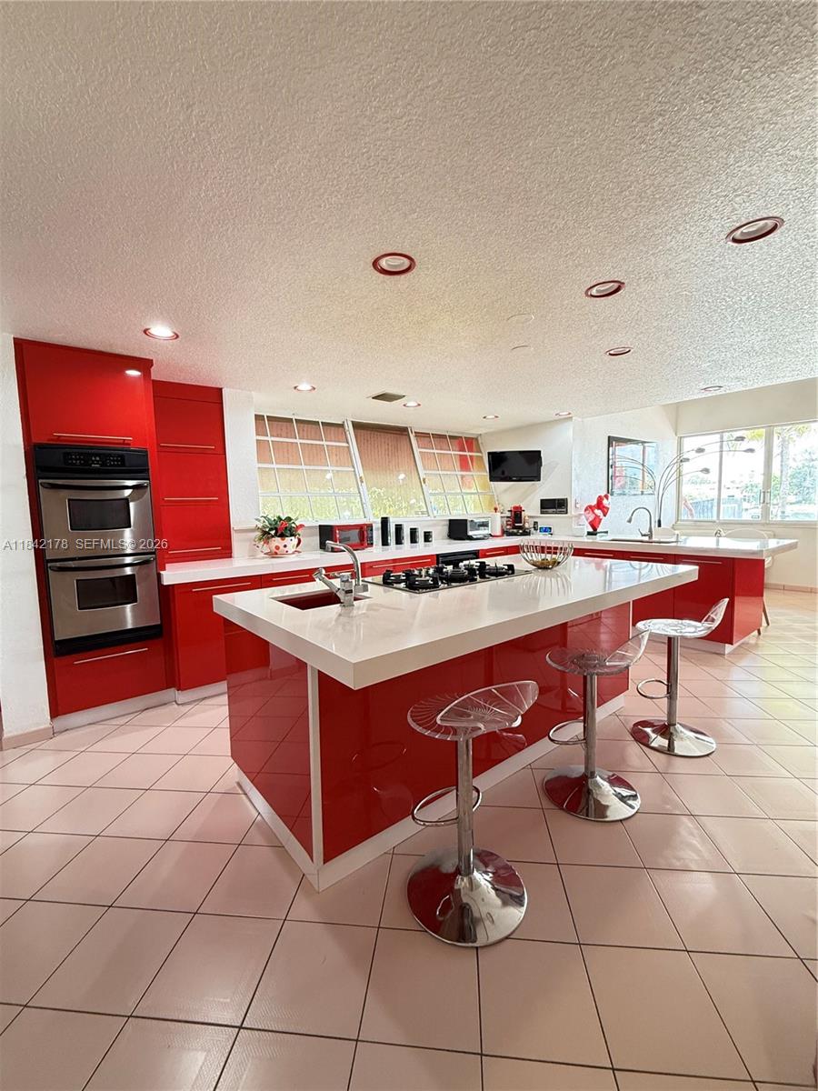747 West 78th Street Hialeah, FL 33014 - Photo 6 of 37 a room with stainless steel appliances kitchen island granite countertop a sink and cabinets