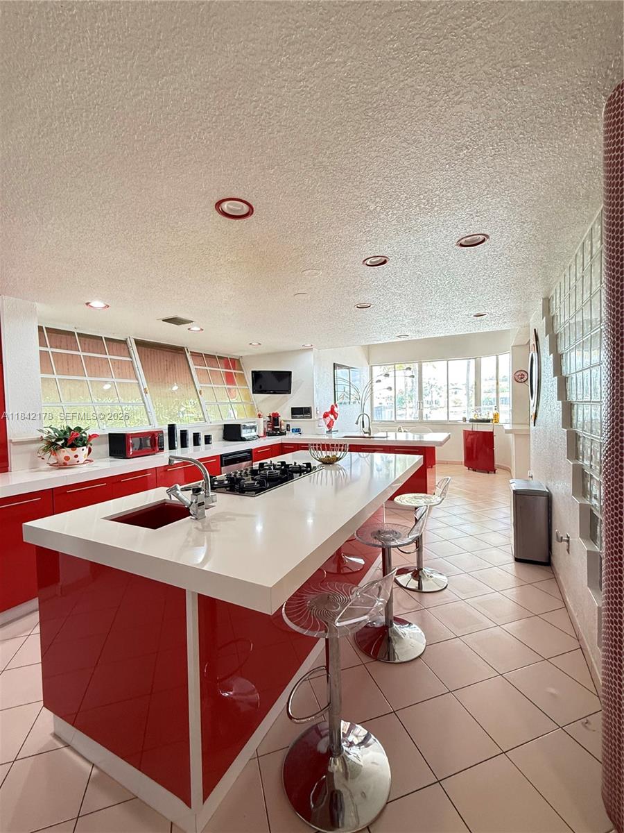 747 West 78th Street Hialeah, FL 33014 - Photo 8 of 37 a dining hall with stainless steel appliances kitchen island granite countertop a sink and a large window