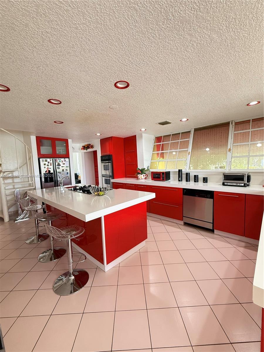 747 West 78th Street Hialeah, FL 33014 - Photo 9 of 38 a kitchen with granite countertop a sink and a stove