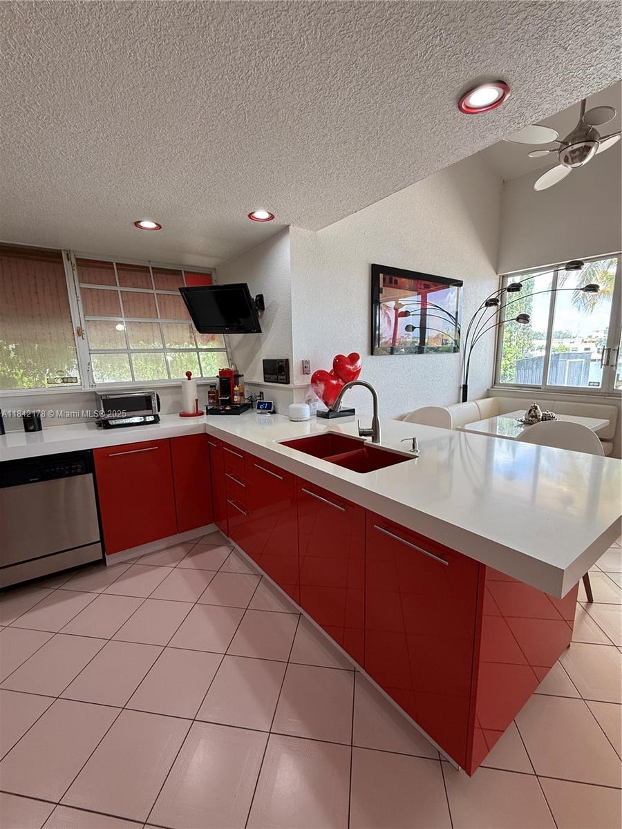 747 West 78th Street Hialeah, FL 33014 - Photo 10 of 38 a kitchen with stainless steel appliances granite countertop a sink counter space cabinets and a sink