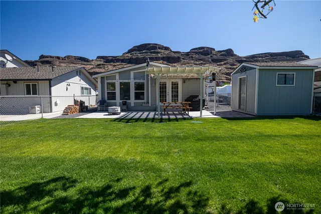 a view of a house with a backyard porch and sitting area