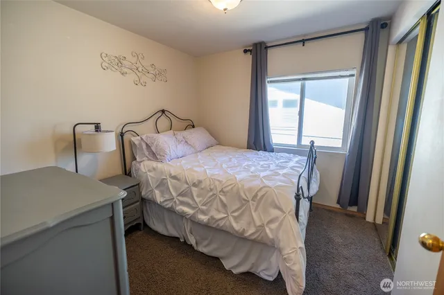 a bedroom with a bed and a table in it